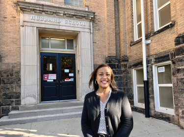 woman standing in front of school building